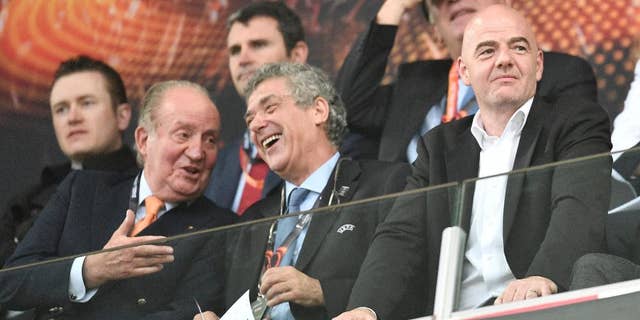 Former King Juan Carlos I of Spain, left, and FIFA president, Gianni Infantino, right, laugh as they wait for the start of the Europa League final soccer match between Liverpool and Sevilla in Basel, Switzerland, Wednesday, May 18, 2016. (AP Photo/Martin Meissner)