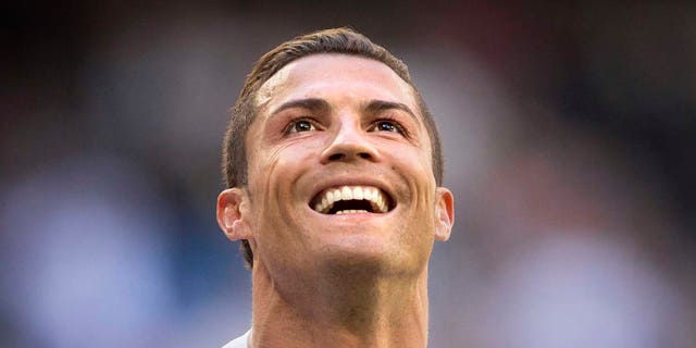 Real Madrid's Cristiano Ronaldo celebrates after scoring a goal during a La Liga soccer match between Real Madrid and Granada at the Santiago Bernabeu stadium in Madrid, Spain, Sunday, April 5, 2015. (AP Photo/Daniel Ochoa de Olza)