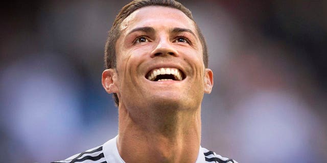 Real Madrid's Cristiano Ronaldo celebrates after scoring a goal during a La Liga soccer match between Real Madrid and Granada at the Santiago Bernabeu stadium in Madrid, Spain, Sunday, April 5, 2015. (AP Photo/Daniel Ochoa de Olza)