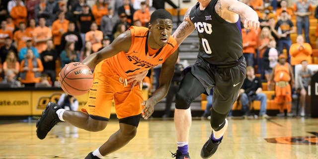 Jan 23, 2017; Stillwater, OK, USA; Oklahoma State Cowboys guard Jawun Evans (1) drives to the basket defended by TCU Horned Frogs guard Jaylen Fisher (0) during the second half at Gallagher-Iba Arena. Cowboys won 89-76. Mandatory Credit: Rob Ferguson-USA TODAY Sports