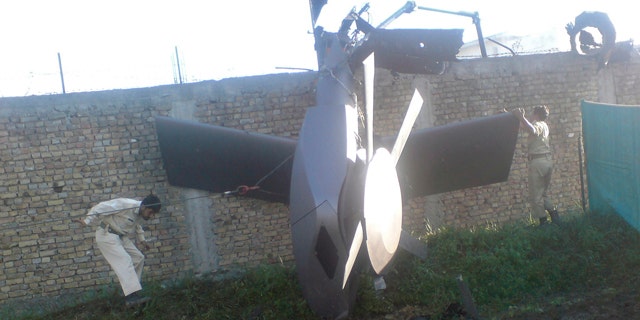 Part of a damaged helicopter is seen lying near the compound after U.S. Navy SEAL commandos killed al Qaeda leader Osama bin Laden in Abbottabad, May  2, 2011. Bin Laden was killed in the U.S. special forces assault on the Pakistani compound, then quickly buried at sea, in a dramatic end to the long manhunt for the al Qaeda leader who had been the guiding star of global terrorism. Picture taken May 2, 2011.   REUTERS/Stringer   (PAKISTAN - Tags: CRIME LAW POLITICS CIVIL UNREST IMAGES OF THE DAY)