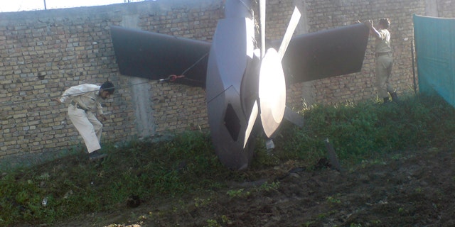 Part of a damaged helicopter is seen lying near the compound after U.S. Navy SEAL commandos killed al Qaeda leader Osama bin Laden in Abbottabad, May 2, 2011. Bin Laden was killed in the U.S. special forces assault on the Pakistani compound, then quickly buried at sea, in a dramatic end to the long manhunt for the al Qaeda leader who had been the guiding star of global terrorism. Picture taken May 2, 2011. REUTERS/Stringer (PAKISTAN - Tags: CRIME LAW POLITICS CIVIL UNREST IMAGES OF THE DAY)