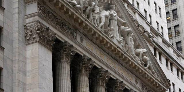The facade of the New York Stock Exchange, Thursday, Oct. 2, 2014. Global stocks were mostly lower Wednesday Dec. 17, 2014 as oil prices tumbled again while investors waited for a U.S. Federal Reserve statement on monetary policy. (AP Photo/Richard Drew)