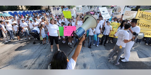 July 2: Thousands of people march through downtown Atlanta in protest against Georgia's strict new immigration law in Atlanta. (AP Photo/Erik S. Lesser)