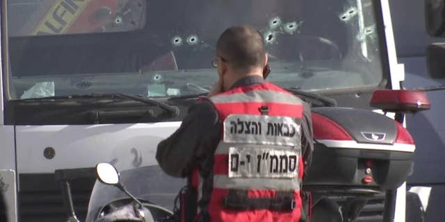 This frame grab from video, shows an Israeli emergency services personnel at scene of a truck-ramming attack in Jerusalem that killed at least four people and wounded several others in Jerusalem, Sunday, Jan. 8, 2017. Israeli police and rescue services said a Palestinian rammed his truck into a group of Israeli soldiers in one of the deadliest attacks of a more than yearlong campaign of violence. Security camera footage shows the truck barreling at a high speed off the road and into the crowd of people in the Armon Hanatziv neighborhood. (AP Photo)