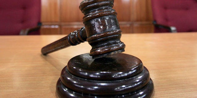 A Sandiganbayan anti-graft court sheriff adjusts chairs inside a courtroom in Quezon city northeast of Manila, Philippines, Tuesday Sept. 11, 2007, where a verdict in ousted Philippine President Joseph Estrada's corruption trial will be announced on Wednesday. (AP Photo/Bullit Marquez)