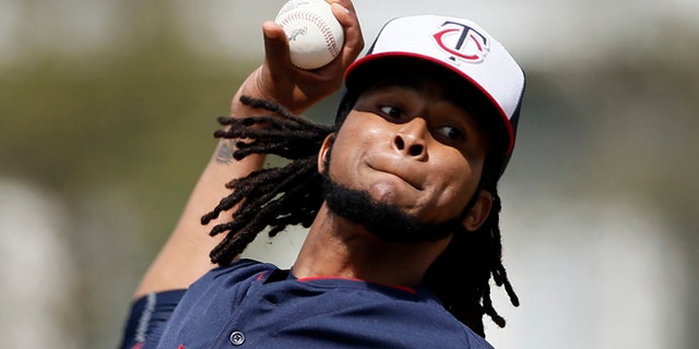 FILE - In this Tuesday March 3, 2015 file photo, Minnesota Twins starting pitcher Ervin Santana (54) throws batting practice at baseball spring training in Fort Myers, Fla. Minnesota Twins pitcher Ervin Santana has been suspended for 80 games by Major League Baseball after testing positive for the performance-enhancing substance Stanozolol. MLB announced the punishment Friday, April 3, 2015. (AP Photo/Tony Gutierrez, File)