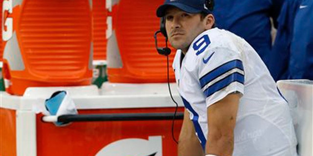 Dallas Cowboys quarterback Tony Romo seats on the beach as watches the action on the big screen television during the second half of an NFL football game against the Washington Redskins in Landover, Md., Sunday, Dec. 22, 2013. (AP Photo/Alex Brandon)