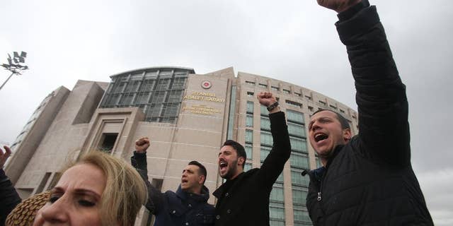 Supporters of the main opposition Republican People's Party, or CHP, chant slogans during a protest outside Istanbul's Court House, Tuesday, April 18, 2017. Hundreds of people are queuing in front of Turkey's election board to submit petitions requesting that the electoral authority reverse a controversial decision during Sunday's referendum to accept ballots without official stamps. (AP Photo/Petros Karadjias)