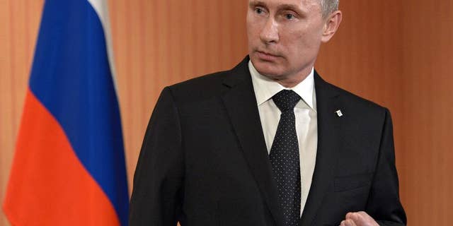 Russian President Vladimir Putin speaks to the media at Benouville castle, Friday, June 6, 2014, where he arrived for the 70th anniversary of the D-Day landings. World leaders and veterans gathered by the beaches of Normandy on Friday to mark the 70th anniversary of World War Two's D-Day landings. (AP Photo/RIA Novosti, Alexei Nikolsky, Presidential Press Service)