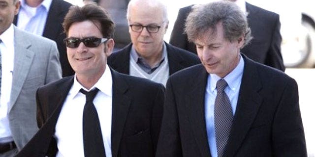 Charlie Sheen (left) and his lawyer leave a court hearing.