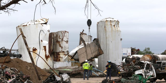 FILE - In this May 2, 2013, file photo investigators move and look through the debris of the destroyed fertilizer plant in West, Texas. Texas law enforcement officials launched a criminal investigation Friday, May 10, 2013, into the massive explosion last month that killed 14 people. (AP Photo/LM Otero, Pool)