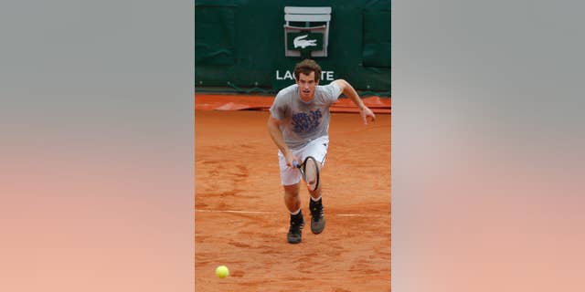 Britain's Andy Murray runs for the ball during a training session for the French Open tennis tournament, at the Roland Garros stadium in Paris, Friday, May 23, 2014. The French Open tennis tournament starts Sunday. (AP Photo/Michel Euler)