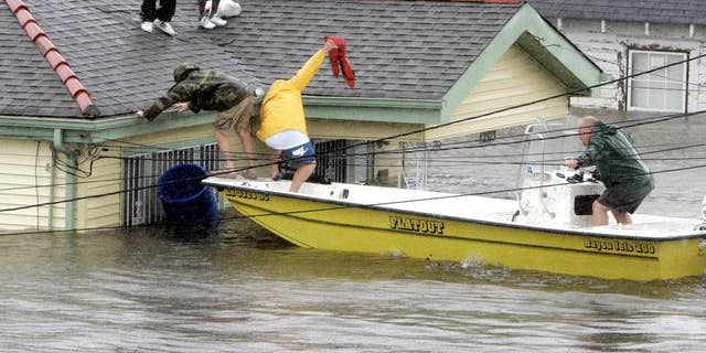 Bryan Vernon and Dorothy Bell are rescued from the roof after the impact of Hurricane Katrina.
