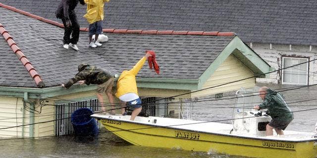 Bryan Vernon and Dorothy Bell are rescued from the roof after the impact of Hurricane Katrina.