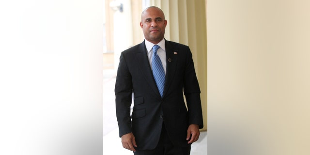FILE - Laurent Lamothe, Haitian Prime Minister and Minister of Foreign Affairs, arrives at Buckingham Palace in London in this July 27, 2012 file photo. Lamothe plans to spend Wednesday Nov. 20, 2013 on a whirlwind tour through Silicon Valley's most elite tech campuses, hoping to convince some of the world's wealthiest and most successful corporate executives to share support and innovation with the poorest country in the Americas. (AP Photo/CARL COURT, File)