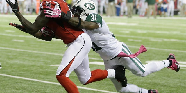 Atlanta Falcons wide receiver Julio Jones (11) misses a catch as New York Jets cornerback Antonio Cromartie (31) defends during the second half of an NFL football game, Monday, Oct. 7, 2013, in Atlanta. (AP Photo/John Bazemore)