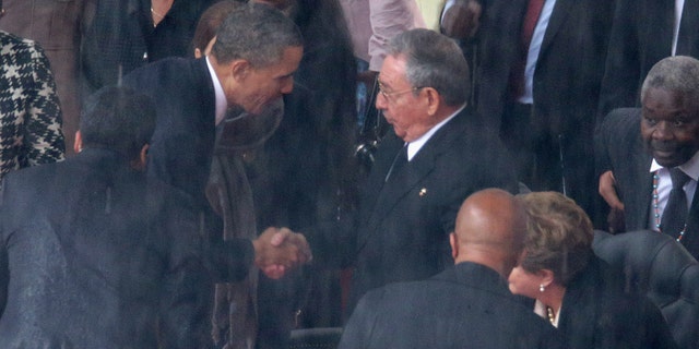 President Obama shakes hands with Cuban President Raul Castro on December 10, 2013 in Johannesburg, South Africa.