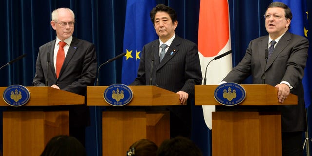 European Commission President Jose Manuel Barroso, right, delivers a speech while Japanese Prime Minister Shinzo Abe, center, and European Council President Herman Van Rompuy, look on during their joint press statement after their EU-Japan summit talks at Abe's official residence in Tokyo Tuesday, Nov. 19, 2013. (AP Photo/Toshifumi Kitamura, Pool)