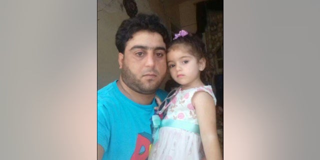 Ghazwan, a Syrian amputee in the rebel-held stronghold of Idlib, pictured with his daughter. He is trying to sell his prosthetic foot to pay back loans and support his family.
