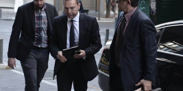 Greek Finance Minister Yiannis Stournaras, center, arrives at the ministry for negotiations with the so-called Troika of Greece's creditors in Athens on Sunday Nov. 10, 2013. Representatives of Greece's creditors started a new round of talks with the government last Tuesday on the conditions for the disbursement of more bailout aid for the debt-ridden country. (AP Photo)