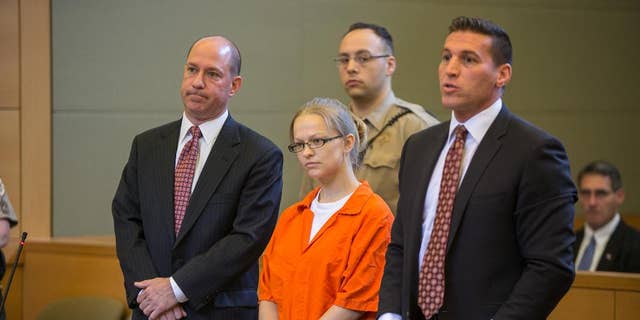 FILE - In this May 29, 2015 file photo, Angelika Graswald, center, stands in court with her attorneys Jeffrey Chartier, left, and Richard Portale at her arraignment in Goshen, N.Y. Authorities say Graswald removed a drain plug from Vincent Viafore's kayak in April 2015 and pushed a floating paddle away from him after his kayak capsized. A Cornwall police officer testified Monday, June 7, 2016, Graswald appeared calm and emotionless after she was rescued. (Allyse Pulliam/Times Herald-Record via AP, Pool, File) MANDATORY CREDIT