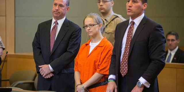 FILE - In this May 29, 2015 file photo, Angelika Graswald, center, stands in court with her attorneys Jeffrey Chartier, left, and Richard Portale at her arraignment in Goshen, N.Y. Authorities say Graswald removed a drain plug from Vincent Viafore's kayak in April 2015 and pushed a floating paddle away from him after his kayak capsized. A Cornwall police officer testified Monday, June 7, 2016, Graswald appeared calm and emotionless after she was rescued. (Allyse Pulliam/Times Herald-Record via AP, Pool, File) MANDATORY CREDIT