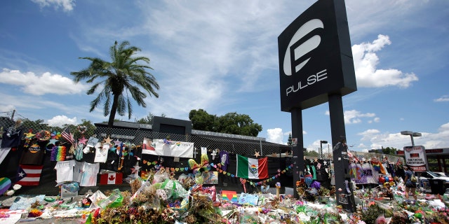 In this July 11, 2016, file photo, a makeshift memorial continues to grow outside the Pulse nightclub, the day before the one month anniversary of a mass shooting, in Orlando, Fla.