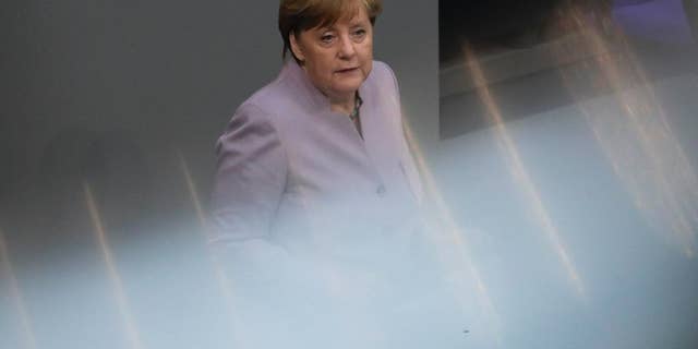 In this photo taken with reflections of a hand rail at the visitors tribune, German Chancellor Angela Merkel delivers her speech about the European Union at the German parliament Bundestag in Berlin, Thursday, April 27, 2017. (AP Photo/Markus Schreiber)