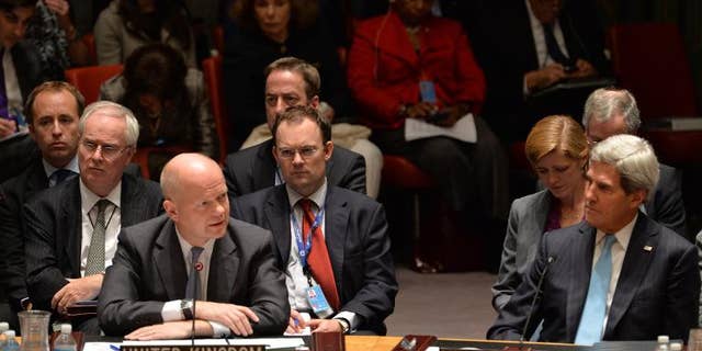 British Foreign Minister William Hague (L) speaks in the UN Security Council just after it voted to approve a resolution that will require Syria to give up its chemical weapons, on September 27, 2013 at the UN headquarters in New York