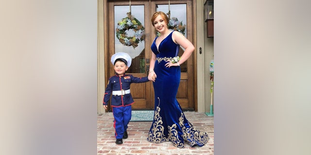 All dressed up in mini Marine Corps dress blues in some of the photos and a tiny tuxedo in the rest, young Clay looks thrilled to be photographed alongside his brother’s girlfriend.