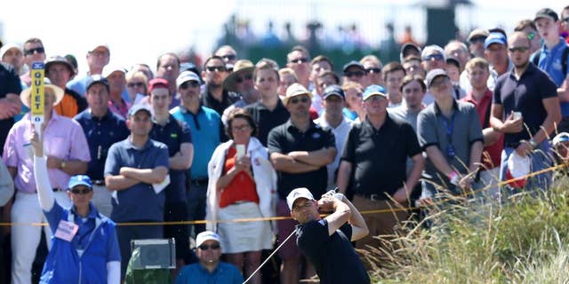 Sergio Garcia of Spain plays a shot off the 14th tee during the first day of the British Open Golf championship at the Royal Liverpool golf club, Hoylake, England, Thursday July 17, 2014. (AP Photo/Scott Heppell)