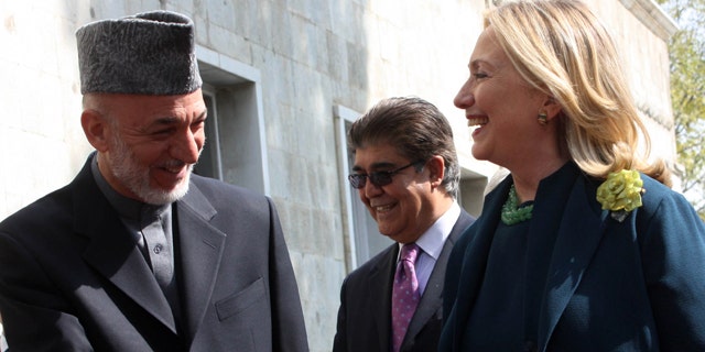 Oct. 20: US Secretary of State Hillary Rodham Clinton, right, shakes hands with Afghanistan's President Hamid Karzai during their meeting in Kabul.