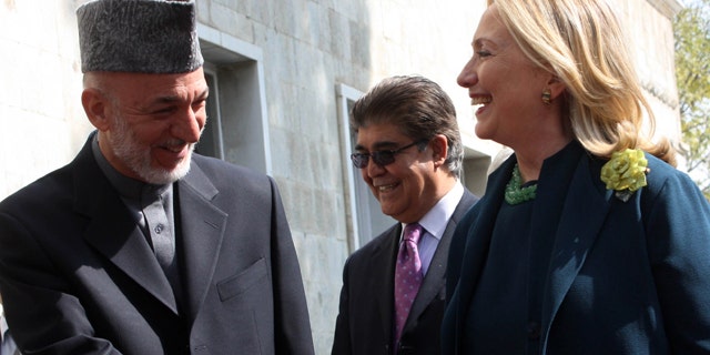 Oct. 20: US Secretary of State Hillary Rodham Clinton, right, shakes hands with Afghanistan's President Hamid Karzai during their meeting in Kabul.
