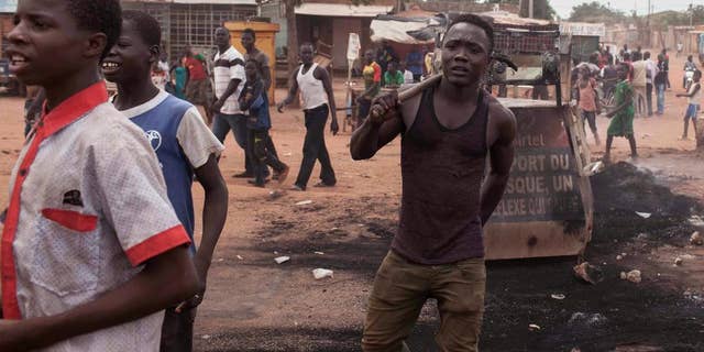 Protestors in the city of Ouagadougou, Burkina Faso, Thursday, Sept. 17, 2015. While gunfire rang out in the streets, Burkina Faso’s military took to the airwaves Thursday to declare it now controls the West African country, confirming that a coup had taken place just weeks before elections. (AP Photo/Theo Renaut)
