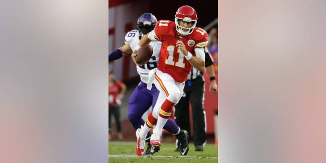 Kansas City Chiefs quarterback Alex Smith (11) runs past Minnesota Vikings defensive end Brian Robison during the first half of an NFL preseason football game in Kansas City, Mo., Saturday, Aug. 23, 2014. (AP Photo/Charlie Riedel)