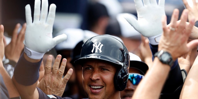 Mar 3, 2016; Tampa, FL, USA; Alex Rodriguez celebrates with high fives as he walks through the dugout after hitting a two run home run against the Philadelphia Phillies (Butch Dill-USA TODAY Sports)