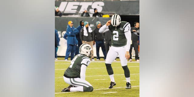 New York Jets kicker Nick Folk (2) reacts after missing a field goal against the Miami Dolphins during the second quarter of an NFL football game, Monday, Dec. 1, 2014, in East Rutherford, N.J. (AP Photo/Bill Kostroun)