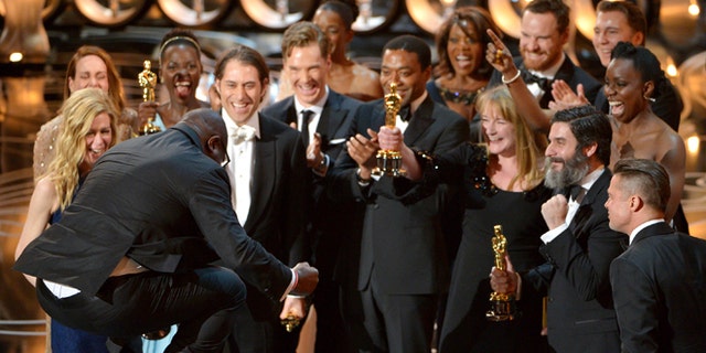 March 2, 2014: Director Steve McQueen, left, celebrates with the cast and crew of "12 Years a Slave" as they accept the award for best picture during the Oscars at the Dolby Theatre in Los Angeles.