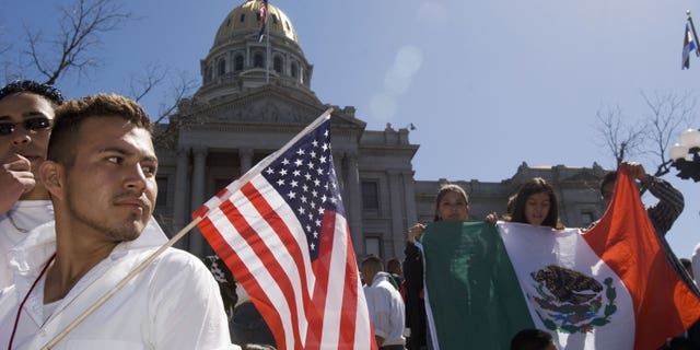 DENVER - APRIL 19: Adrian Campos, 16, holds a U.S. flag during a rally with about 3,000 middle and high school students who walked out of school April 19, 2006 in Denver, Colorado. The students gathered on the steps of the Colorado state Capitol to demonstrate in support of immigrant rights and against U.S. Congressional immigration reform proposals. (Photo by Kevin Moloney/Getty Images)