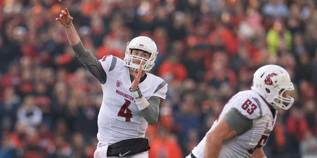 Washington State quarterback Luke Falk (4) throws a pass during an NCAA college football game against Oregon State in Corvallis, Ore., Saturday, Nov. 8, 2014. The Cougars beat the Beavers 39-32. (AP Photo/Troy Wayrynen)