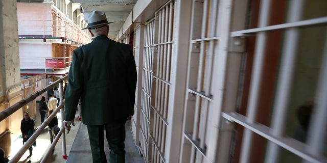 SAN FRANCISCO, CA - MARCH 21:  National Park Service ranger Roger Goldberg walks through the main cell block at Alcatraz Island on March 21, 2013 in San Francisco, California.  The National Park Service marked the 50th anniversary of the closure of the notorius Alcatraz federal penitentiary with an exhibit of newly discovered photos by Los Angeles freelance photographer Leigh Wiener of the prison's final day in 1963. Alcatraz was first a fort and later became an Army disciplinary barracks before being taken over by the Bureau of Prisons in 1934.  (Photo by Justin Sullivan/Getty Images)