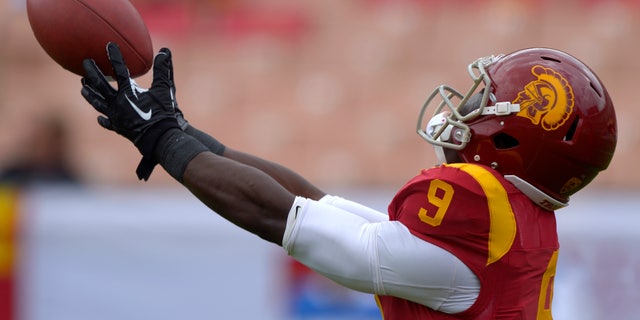 FILE - In this Sept. 21, 2013, file photo, Southern California wide receiver Marqise Lee catches a pass during warm-ups prior to an NCAA college football game against Utah State in Los Angeles. Already depleted by NCAA sanctions, USC is rapidly running out of healthy players midway through its tumultuous season. (AP Photo/Mark J. Terrill, File)