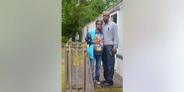 HFM April 13 In this April 12, 2016, photo, Lakeya Hicks and Elijah Pontoon stand outside their home in Aiken, South Carolina. The couple is speaking out about the 2014 traffic stop they say ended in public humiliation over an invasive cavity search for drugs that didn't exist. Hicks and Pontoon are suing the Aiken Department of Public Safety for illegally searching them on the side of a busy road. (AP Photo/Meg Kinnard)