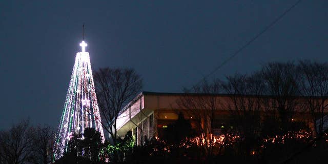 This Tuesday, Dec. 21, 2010 photo shows a giant steel Christmas tree lit up at the western mountain peak known as Aegibong in Gimpo, South Korea. A South Korean church group has canceled plans to erect the giant Christmas tree near the border with North Korea after locals complained that it could provoke Pyongyang. (AP Photo/Lee Jin-man)