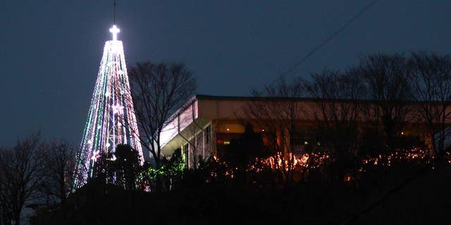 This Tuesday, Dec. 21, 2010 photo shows a giant steel Christmas tree lit up at the western mountain peak known as Aegibong in Gimpo, South Korea. A South Korean church group has canceled plans to erect the giant Christmas tree near the border with North Korea after locals complained that it could provoke Pyongyang. (AP Photo/Lee Jin-man)