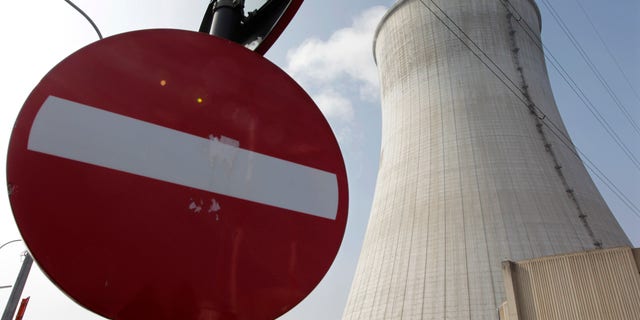 FILE - In this March 16, 2011 file photo, steam is emitted from the cooling tower at the nuclear power plant in Tihange, Southeast of Brussels. A Belgian utility company said on Wednesday, Feb. 27, 2013 that an unexploded World War I shell was found on the grounds of the nuclear power plant but was safely removed by military experts. An Electrabel spokeswoman said the shell was found during construction work Wednesday in front of an administrative building outside the reactor’s fenced security perimeter. Staff were briefly evacuated. (AP Photo/Yves Logghe, File)