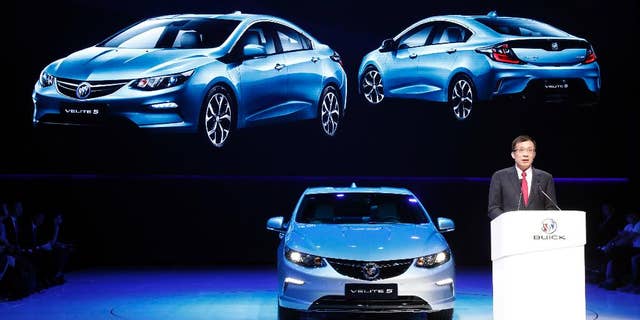SAIC-GM president Wang Yongping announces the global launch of the Buick Velite 5, an extended range electric hybrid, during a global launch event ahead of the Shanghai Auto 2017 show in Shanghai, China, Tuesday, April 18, 2017. At the auto show, the global industry's biggest marketing event of the year, almost every global and Chinese auto brand is showing at least one electric concept vehicle, if not a market-ready model. (AP Photo/Ng Han Guan)