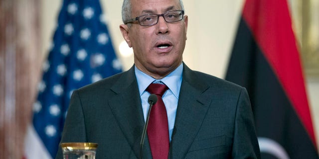 FILE - In this March 13, 2013 file photo, Libyan Prime Minister Ali Zidan speaks during a joint news conference with U.S. Secretary of State John Kerry at the State Department in Washington. Libya's parliament passed a law on Sunday, May 5, 2013, that bans officials who held senior positions under ousted dictator Moammar Gadhafi from holding high-level government posts, a move that could disqualify much of the country's political elite from office including Prime Minister Ali Zidan, who served as a diplomat under Gadhafi. (AP Photo/Jose Luis Magana, File)
