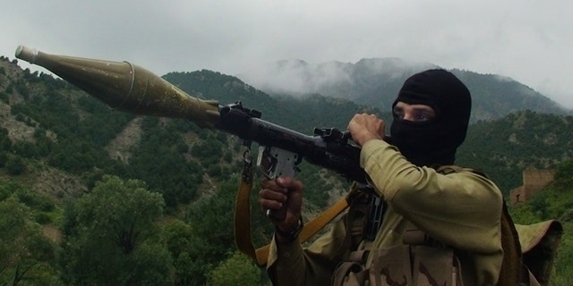 In this photo taken on Aug. 5, 2012, a Pakistani Taliban militant holds a rocket-propelled grenade at the Taliban stronghold of Shawal, South Waziristan, Pakistan. Taliban leaders will hold a meeting to decide whether a Pakistani cricket star-turned-politician Imran Khan will be allowed to hold a planned march to their tribal stronghold to protest U.S. drone strikes, the militant group's spokesman said Thursday. (AP Photo/ Ishtiaq Mahsud)